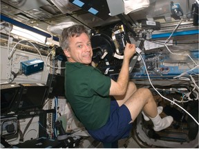 June 30, 2009 -- Bob Thirsk on the International Space Station works on an experiment that tests how astronaut perceive the concepts of up and down in Zero-G.   (Credit NASA)