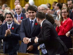 Prime Minister Justin Trudeau receives a handshake after delivering a formal apology over the fate of the MS St. Louis and its passengers in the House of Commons on Parliament Hill in Ottawa on Wednesday, Nov. 7, 2018.