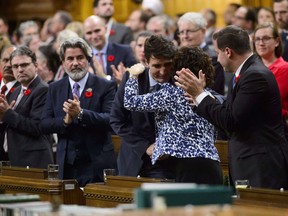 Prime Minister Justin Trudeau receives a hug from MP Linda Lapointe after delivering a formal apology over the fate of the MS St. Louis and its passengers in the House of Commons on Parliament Hill in Ottawa on Wednesday, Nov. 7, 2018.