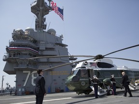 President Donald Trump walks to board Marine One on the flight deck of the USS Gerald R. Ford (CVN 78) at Naval Station Norfolk, Va., Saturday, July, 22, 2017, after the commissioning ceremony of the aircraft carrier.