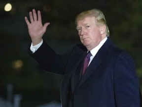 U.S. President Donald Trump waves after stepping off Marine One on the South Lawn of the White House, Sunday, Nov. 25, 2018, in Washington. Trump is returning from his Mar-a-Largo resort in Florida.