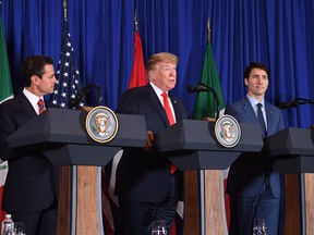 Mexican President Enrique Pena Nieto, US President Donald Trump and Canadian Prime Minister Justin Trudeau deliver a statement on the signing of a new free trade agreement in Buenos Aires, on November 30, 2018, on the sidelines of the G20 Leaders' Summit.