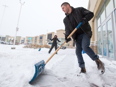 Luke Smith clears snow in College Square as the region deals with the first significant snowfall in November.