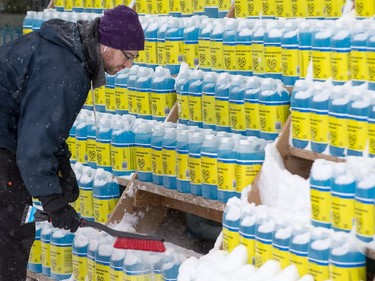 Matt Peck, General merchandise manager at Loblaws in College Square, stocks the outside display of windshield washer fluid as the region deals with the first significant snowfall in November.