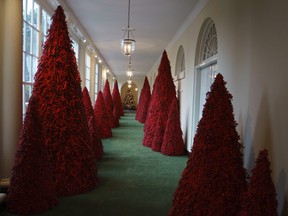 Topiary trees line the East colonnade during the 2018 Christmas Press Preview at the White House in Washington, Monday, Nov. 26, 2018. Christmas has arrived at the White House. First lady Melania Trump unveiled the 2018 White House holiday decor on Monday. She designed the decor, which features a theme of "American Treasures."