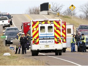 Emergency medical personnel gather at the scene of a hit-and-run accident Saturday, Nov. 3, 2018, in Lake Hallie, Wis., that killed two girls and an adult.