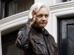 In this May 19, 2017, file photo, WikiLeaks founder Julian Assange greets supporters from a balcony of the Ecuadorian embassy in London.