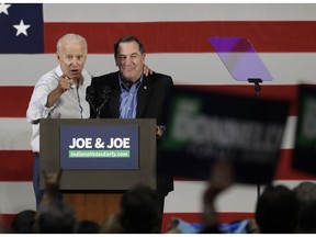 In this Oct. 12, 2018 photo, former Vice President Joe Biden, left, and Democratic Sen. Joe Donnelly speak during a rally in Hammond, Ind. Republicans have a huge advantage as they seek to hold or expand their 51-49 Senate majority, with the battle for control running mostly through states that President Donald Trump won in 2016.