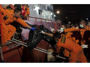 Rescuers hand body bags containing the remains of the victims of the crashed Lion Air jet to colleagues upon arrival at Tanjung Priok Port in Jakarta, Indonesia, Saturday, Nov. 3, 2018. The brand new Boeing 737 MAX 8 jet plunged into the Java Sea just minutes after takeoff from Jakarta early on Oct. 29, killing all of its passengers on board.