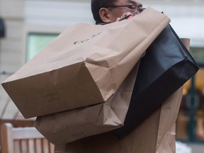 A man carries shopping bags of Boxing Day sale purchases