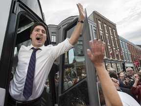 Liberal Leader Justin Trudeau waves to supporters as he boards the campaign bus following a rally in downtown Port Hope, Ont. in October, 2015.