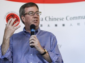 Mayor Jim Watson appears at a Community Welcome Fair for Immigrants and Newcomers, organized by the Ottawa Chinese Community Service Centre, in this file picture. It's time for some Chinese-language signs, writes Amy Yee.