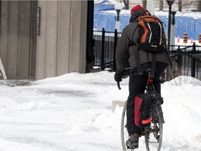 A man rides his bike in the wintery weather of Ottawa, in this file photo.