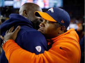 Vance Joseph hugs Chargers head coach Anthony Lynn after Saturday's game in Denver. It was the last game as Broncos coach for Joseph before he was fired.