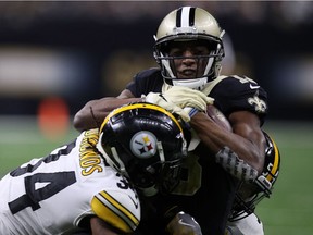 Michael Thomas #13 of the New Orleans Saints is tackled by Terrell Edmunds #34 of the Pittsburgh Steelers  during the second half at the Mercedes-Benz Superdome on December 23, 2018 in New Orleans, Louisiana.
