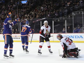 (l-r) Matt Martin #17 and Anders Lee #27 of the New York Islanders celebrate Lee's2p goal against Mike McKenna #33 of the Ottawa Senators at the Barclays Center on December 28, 2018 in the Brooklyn borough of New York City.