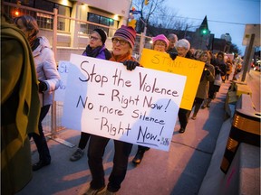 Marchers show their support for the campaign violence against women and girls on Saturday during the procession from Minto Park to the Ottawa Human Rights Monument.