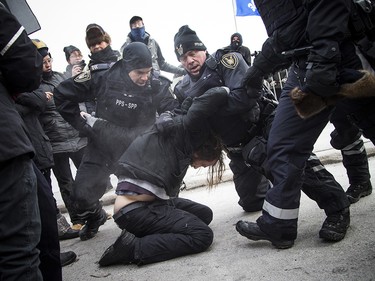 Groups opposed to Canada’s support of the UN Global Compact for Safe, Orderly and Regular Migration held a rally to protest the United Nation Global Compact for Migration while anti-fascism and anti-racism activists counter-protested, Saturday, Dec. 8, 2018 on Parliament Hill. One of multiple anti-fascism and anti-racism activists who were detained when the protest erupted.