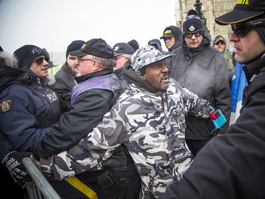 Groups opposed to Canada’s support of the UN Global Compact for Safe, Orderly and Regular Migration held a rally to protest the United Nation Global Compact for Migration while anti-fascism and anti-racism activists counter-protested, Saturday, Dec. 8, 2018 on Parliament Hill. Far-right groups get pushed into a specified area on the front lawn or Parliament.