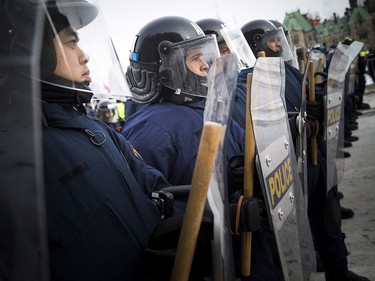 Groups opposed to Canada’s support of the UN Global Compact for Safe, Orderly and Regular Migration held a rally to protest the United Nation Global Compact for Migration while anti-fascism and anti-racism activists counter-protested, Saturday, Dec. 8, 2018 on Parliament Hill. RCMP tactical unit was on the hill to help keep the two sides apart.