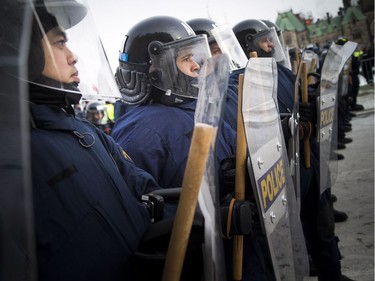 Groups opposed to Canada’s support of the UN Global Compact for Safe, Orderly and Regular Migration held a rally to protest the United Nation Global Compact for Migration while anti-fascism and anti-racism activists counter-protested, Saturday, Dec. 8, 2018 on Parliament Hill. RCMP tactical unit was on the hill to help keep the two sides apart.