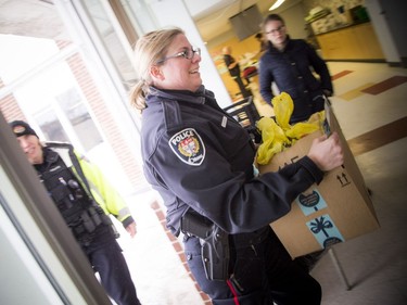 Ottawa Police Service community officer Stephanie Lemieux was one of the volunteers helping to pack food hampers at the Caldwell Family Centre on Saturday.