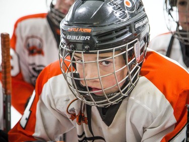 Philadelphia Little Flyers, including #4 Dylan Orr, gathered at the boards to listen to the coaches.