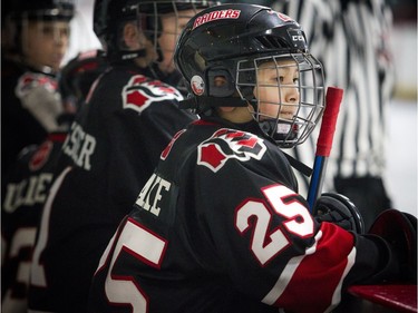 Nepean Raiders #25 James Lake keeps a close eye on the game while he takes a little rest on the bench.