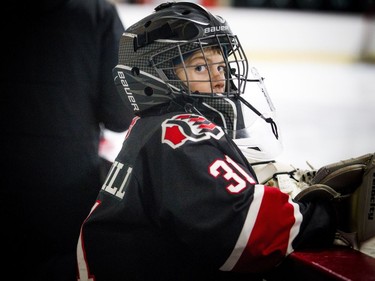 Nepean Raiders goalie #31 Cohen Underhill notices the photographer behind him on the bench.