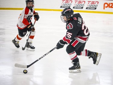 Nepean Raiders #25 James Lake with the puck during the first period.