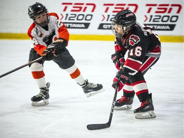 Nepean Raiders #16 Thomas Vandenberg brings the puck down the ice.