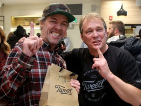Ian Power (along with Nikki Rose, not pictured)  became the first people to legally buy pot in Canada at midnight on Oct. 17, 2018 at the Tweed store in Newfoundland.  Ottawa's Bruce Linton, (right, founder, CEO and Chairman of Canopy Growth) travelled from Ottawa to make the sale.