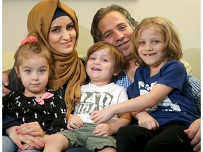 Basel Al Zoubi, pictured here at his South Keys home with his wife Maes and children - Amir, 6, Maria, 4, and Moussa, arrived in Ottawa on New Year's Eve, 2015 after fleeing war-torn Syria.