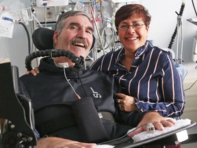 Retired colonel Greg Hug is seen with his wife, Maria, in his hospital room, where he has lived for most of the past two and a half years since being seriously injured in Barbados.