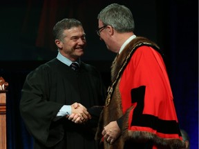 Tim Tierney, Councillor for Ward 11 Beacon Hill-Cyrville is congratulated by Ottawa Mayor Jim Watson prior to signing the Oath of Office during the Inauguration ceremony for Ottawa's new City Council, December 03, 2018.