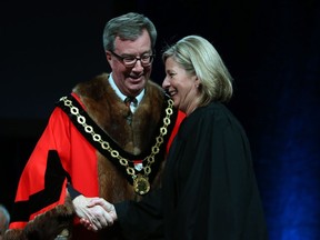 Carol Anne Meehan, councillor for Ward 22, Gloucester-South Nepean, is congratulated by Ottawa Mayor Jim Watson prior to signing the Oath of Office on Dec. 3, 2018.