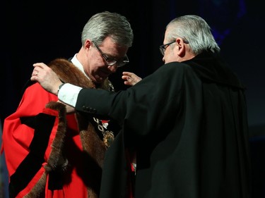 Jim Watson receives the Chain of Office by Rick O'Connor, city clerk and solicitor, during the inauguration ceremony for Ottawa's new city council, Dec. 03, 2018.