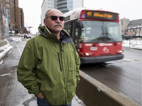 Mike Deriger lost an eye in an incident on an OC Transpo bus in December 2015 as the bus was going from Gatineau to Ottawa. Mike poses for a photo where the incident took place as a bus drives by. December 6, 2018. Errol McGihon/Postmedia