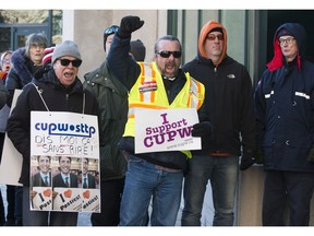 Allies of postal workers, including CUPW Local 580 president Ian Anderson (yellow vest), protest outside the Canada Post annual meeting in Ottawa. December 12, 2018.