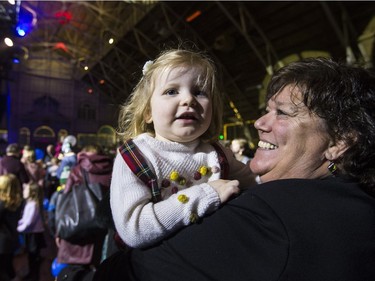 Jane Torrance and her two-year-old granddaughter Grace McKenna take in the Hogman-eh! celebration on Monday night.