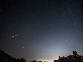 A meteor streaks through the sky.