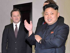 In this file photo taken on January 8, 2014 North Korean leader Kim Jong Un stands with Michael Spavor at Pyongyang Gymnasium in Pyongyang.