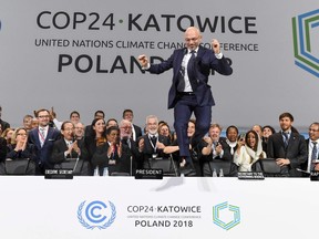 COP24 president Michal Kurtyka jumps at the end of the final session of the COP24 summit on climate change in Katowice, Poland, on Saturday.