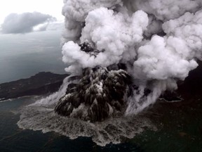 This aerial picture taken on December 23, 2018 by Bisnis Indonesia shows the Anak (Child) Krakatoa volcano erupting in the Sunda Straits off the coast of southern Sumatra and the western tip of Java. - The death toll from the December 22 volcano-triggered tsunami in Indonesia has risen to 281, with more than 1,000 people injured, the national disaster agency said on December 24, as the desperate search for survivors ramped up.