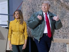 U.S. President Donald Trump and First Lady Melania Trump arrive to speak to members of the U.S. military during an unannounced trip to Al Asad Air Base in Iraq on December 26, 2018.