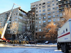 This handout picture released by The Russian Emergency Situations Ministry on December 31, 2018, shows emergency officers as they gather after a gas explosion rocked a residential building in Russia's Urals city of Magnitogorsk.