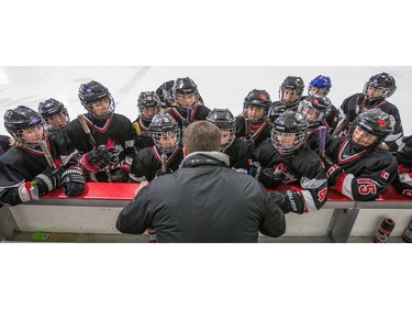Head coach Rob Ronberg talks to his team, the Nepean Wildcats in the Girls Atom AA division before playing against the Whitby Wolves as the annual Bell Capital Cup hockey tournament for Peewee and Atom level players gets underway at the Bell Sensplex and various arenas across the city.