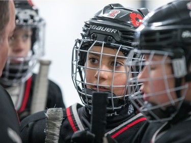 Mallea McMullin of the Nepean Wildcats in the Girls Atom AA division listens to her coach before playing against the Whitby Wolves as the annual Bell Capital Cup hockey tournament for Peewee and Atom level players gets underway at the Bell Sensplex and various arenas across the city.