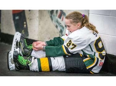 Sofia Starr, 10, ties up her skates before competing with her team the Stoney Creek Sabres in the Girls Atom AA division as the annual Bell Capital Cup hockey tournament for Peewee and Atom level players gets underway at the Bell Sensplex and various arenas across the city.
