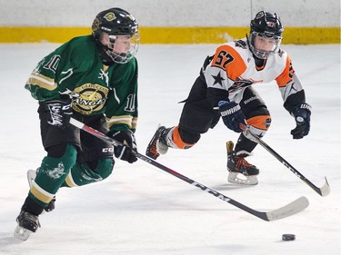 Brandon Lucia of the Minor Peewee AA Clifton Park Dynamo team (R) tries to close the gap on Lukas Murphy of  the Gloucester Rangers as the annual Bell Capital Cup hockey tournament for Peewee and Atom level players gets underway at the Bell Sensplex and various arenas across the city.